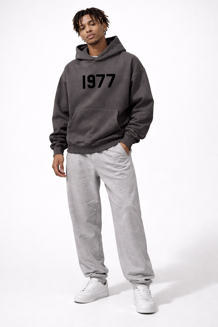Stylish dark grey men's retro 1977 raglan streetwear hoodie, perfect for an urban casual look.