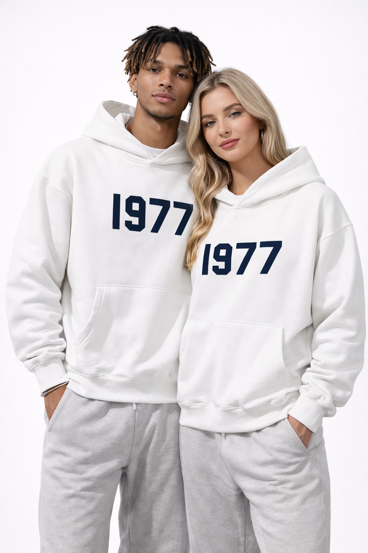 Side view of men's retro 1977 raglan hoodie, highlighting the unique sleeve design and vintage print.