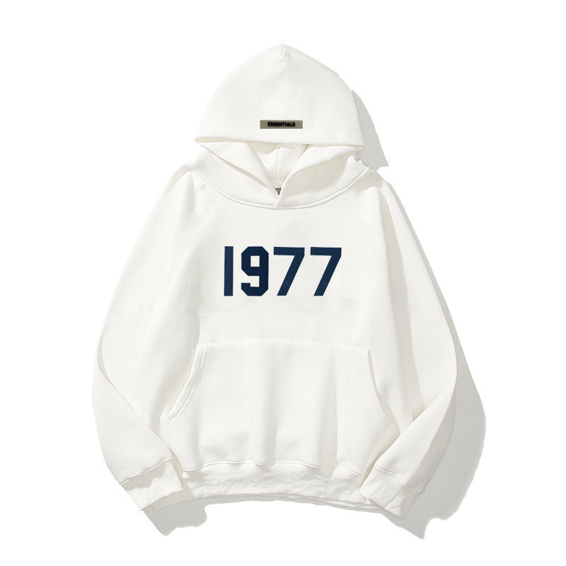 Man models a men's retro 1977 raglan hoodie, showcasing its comfortable fit for casual streetwear.