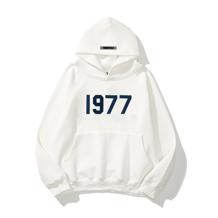 Man models a men's retro 1977 raglan hoodie, showcasing its comfortable fit for casual streetwear.