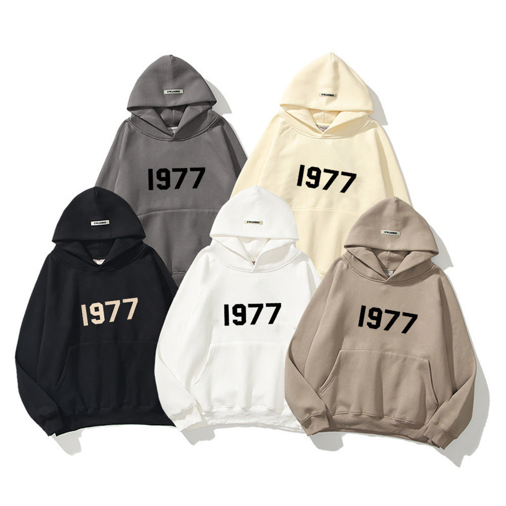Close-up of the distressed 1977 print on a men's retro raglan sleeve streetwear pullover hoodie.