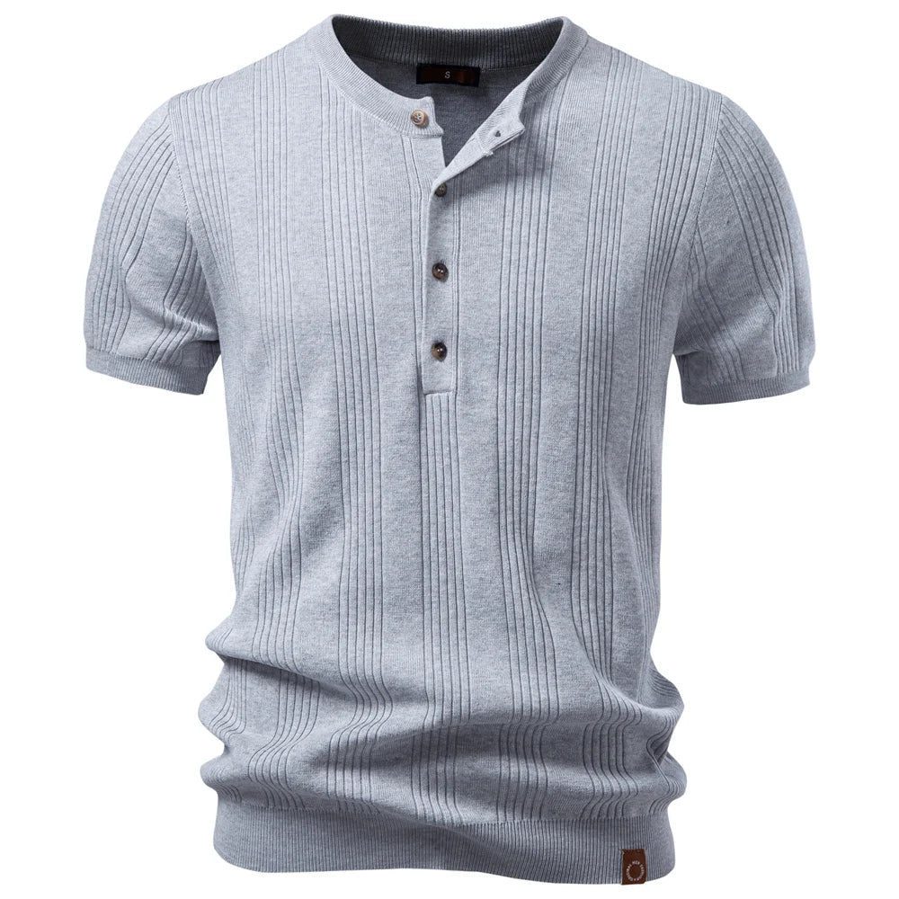 Close-up of a men's ribbed knit henley shirt, showing textured fabric and button placket for a structured look.