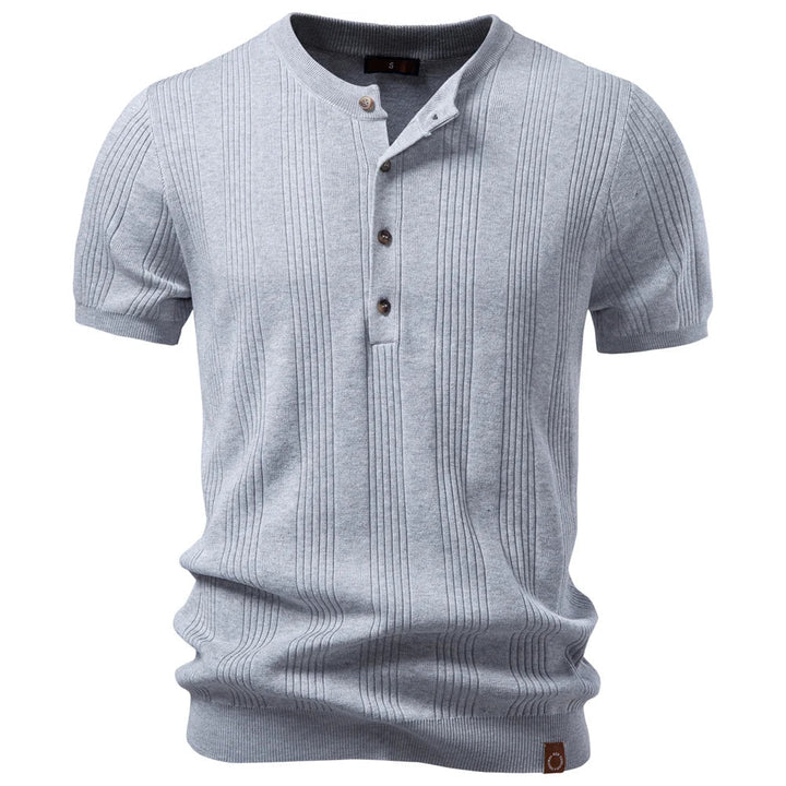 Close-up of a men's ribbed knit henley shirt, showing textured fabric and button placket for a structured look.