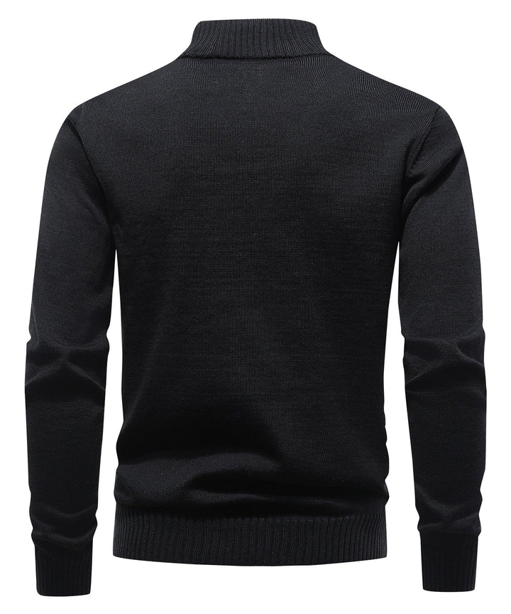 Close-up of the ribbed texture on a men's black mock neck half-zip sweater, a versatile top