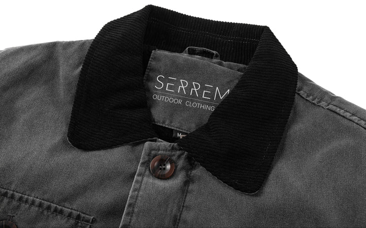 Full-length shot of a man in a black canvas utility jacket, suitable for rugged everyday wear.