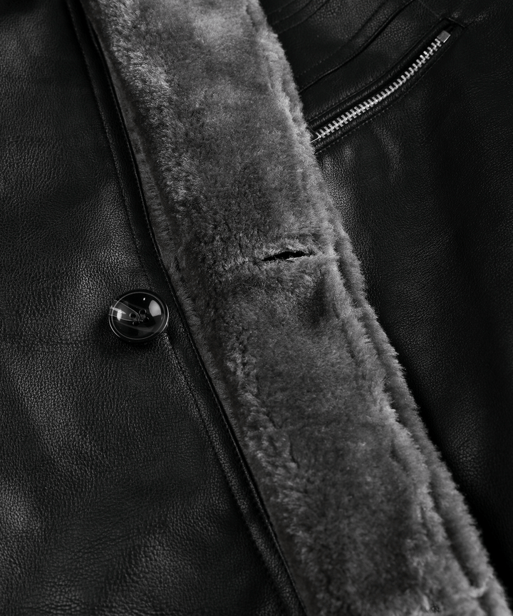 Black men's arctic winter jacket on a hanger, highlighting its rugged and insulated features