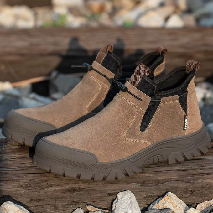 Various men's steel-toe work boots in brown and black, showcasing rugged safety footwear
