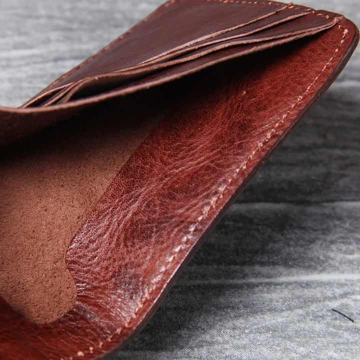 Men's bifold wallet in tan leather, featuring a compact and slim profile.