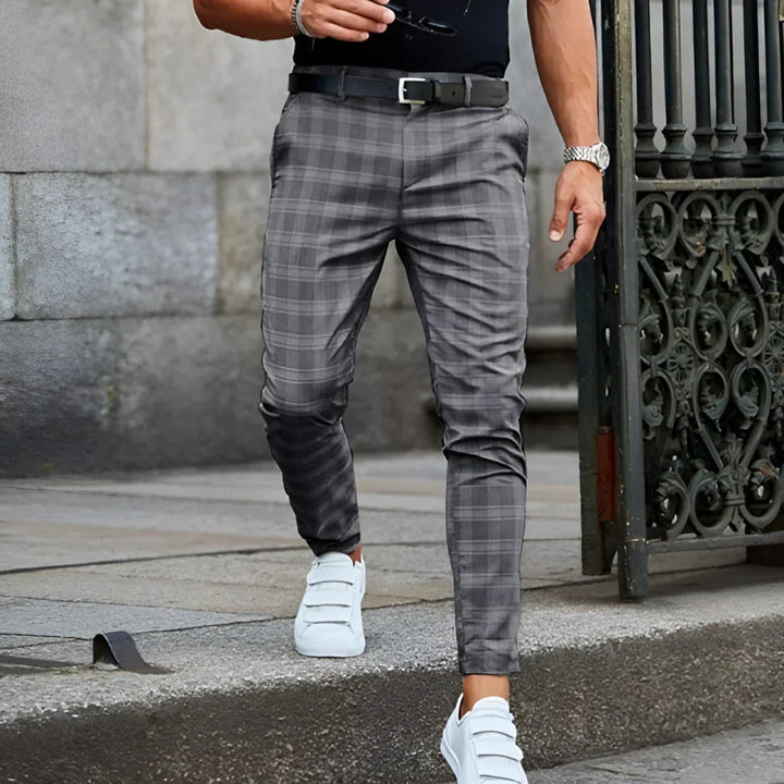 Close-up of men's slim fit cropped checked pants, showcasing the checked pattern and ankle-length cut.
