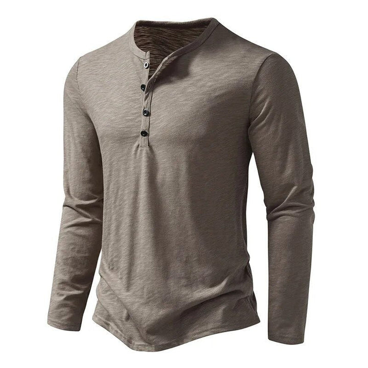 Comfortable men's long sleeve henley top with button placket, perfect for casual wear.