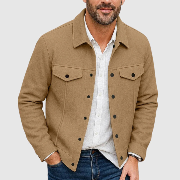 Man wearing a trendy men's shirt jacket, styled open over a t-shirt, perfect for a layered fall outfit.