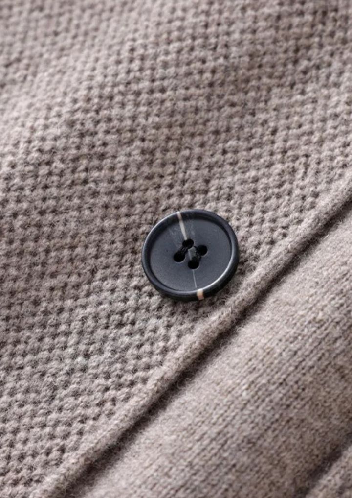 Men's casual button-up cardigan sweater, a relaxed fit knitwear piece with front pockets for versatile styling.
