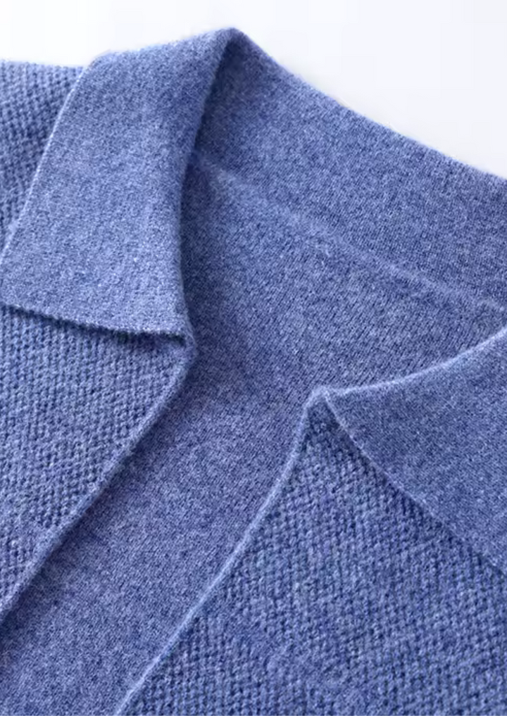 Relaxed fit men's cardigan sweater with button-up front, collar, and practical front pockets. Stylish and versatile.