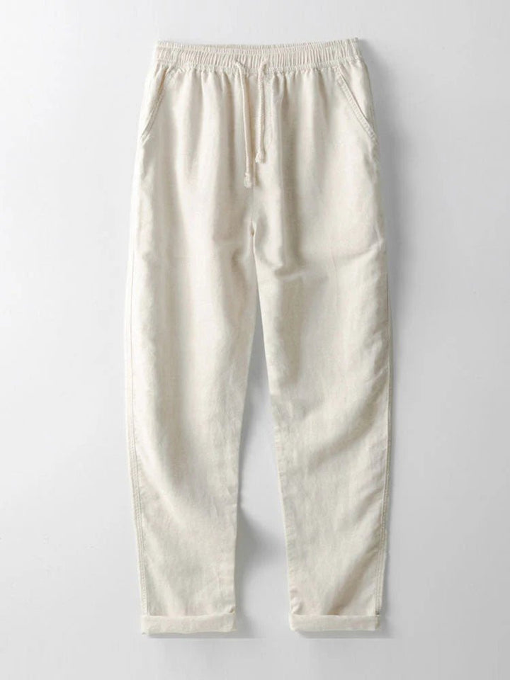 Stylish men's two-piece summer outfit: casual shirt & pants set. Relaxed fit, rolled cuffs, beach style.