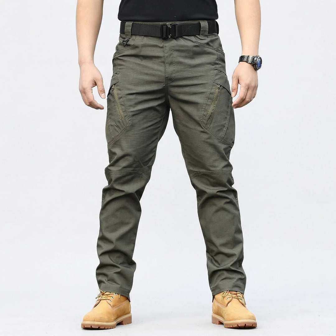 Weather-resistant men's tactical pants, durable fabric, 9 pockets, great for work, hiking & adventure.