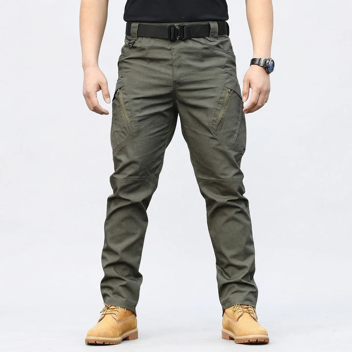 Weather-resistant men's tactical pants, durable fabric, 9 pockets, great for work, hiking & adventure.