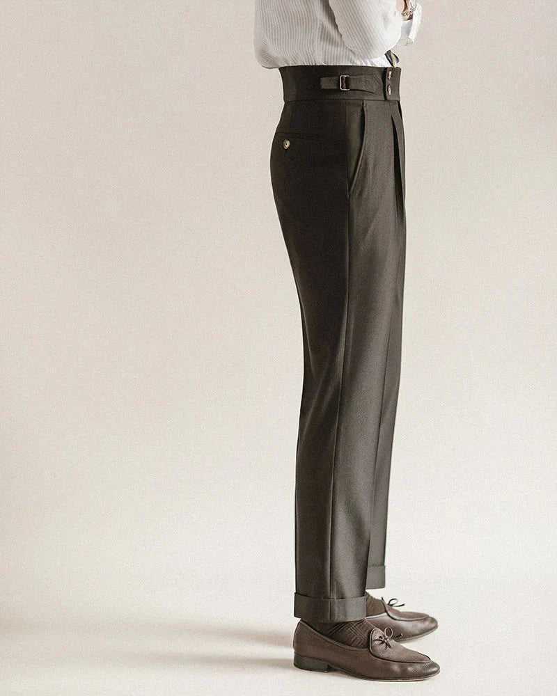 Stack of men's tailored business trousers in various colors: black, grey, navy, for officewear.