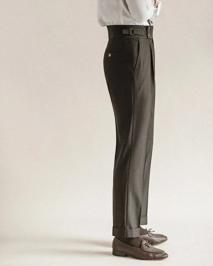 Stack of men's tailored business trousers in various colors: black, grey, navy, for officewear.