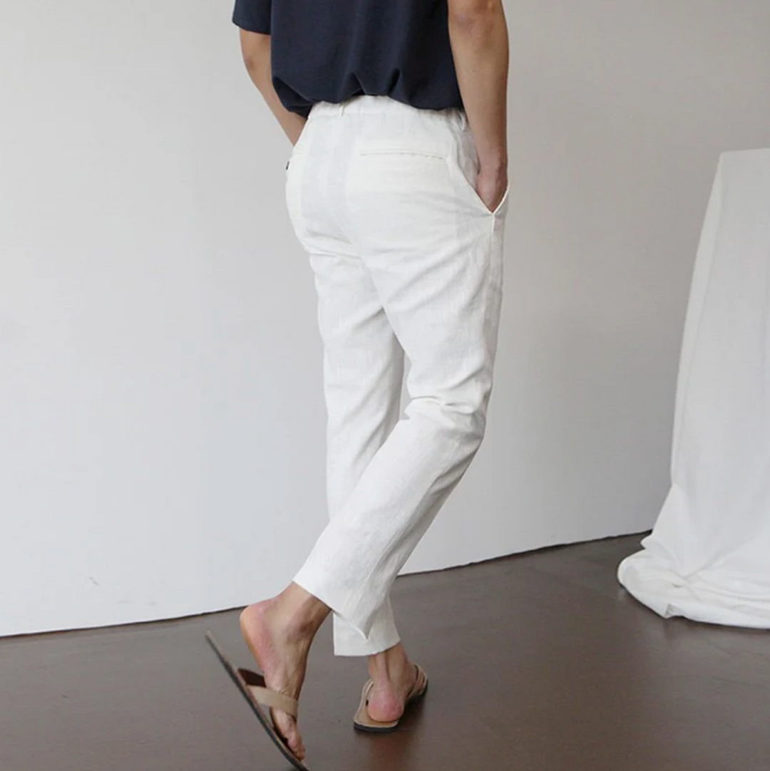 Close-up of men's breathable summer trousers fabric, showing lightweight material and tailored waistband.