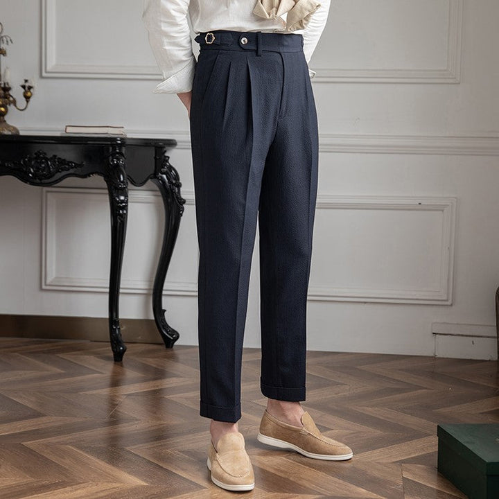 Men's tailored high-waist pleated trousers for modern formal wear. Smart dress pants.