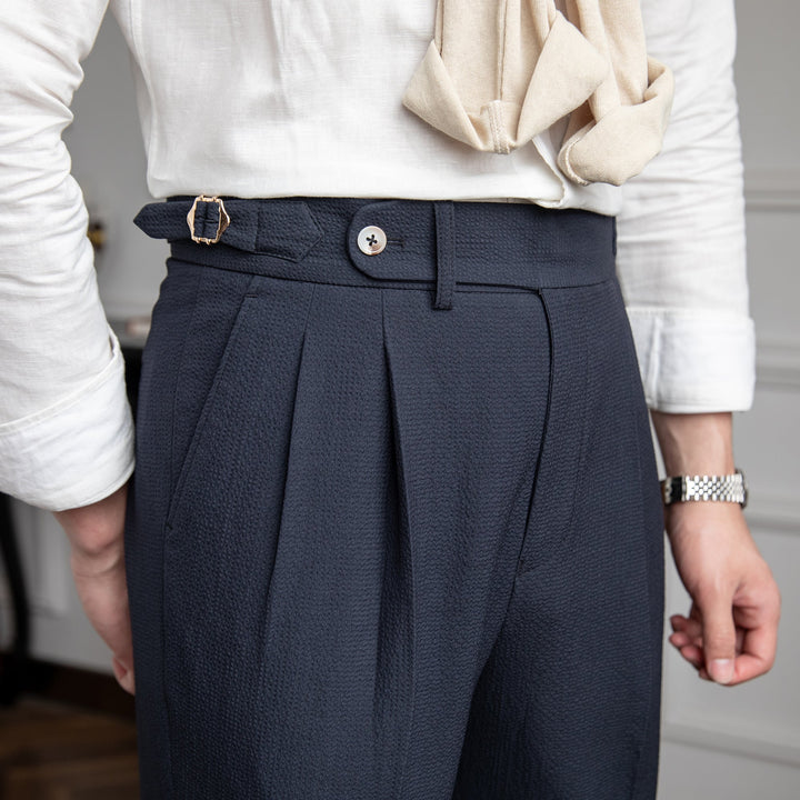 Elegant tailored men's high-waist dress pants with stylish pleats; contemporary men's fashion.