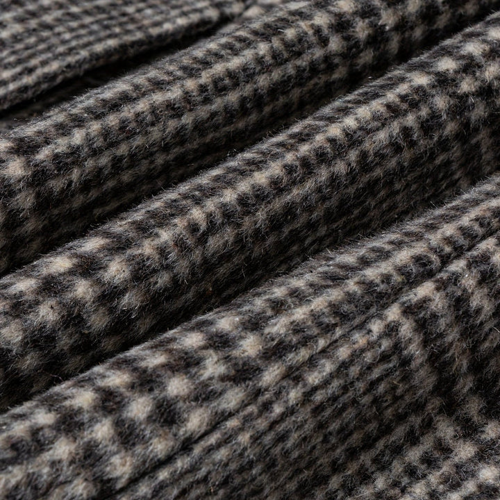 Detail of the collar and lapels on a men's plaid wool blend overcoat, highlighting tailoring