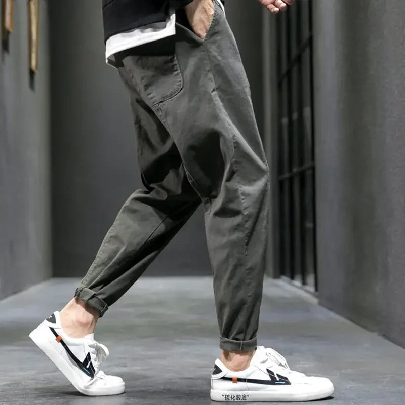 Men's tapered joggers paired with a t-shirt and sneakers, demonstrating a complete casual outfit.