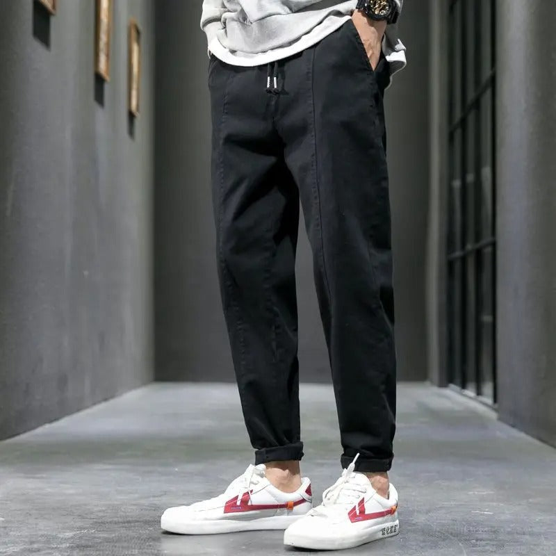 Lifestyle shot of a man walking in men's tapered joggers, ideal for everyday comfort and lounge.