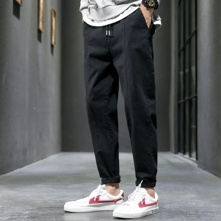 Lifestyle shot of a man walking in men's tapered joggers, ideal for everyday comfort and lounge.