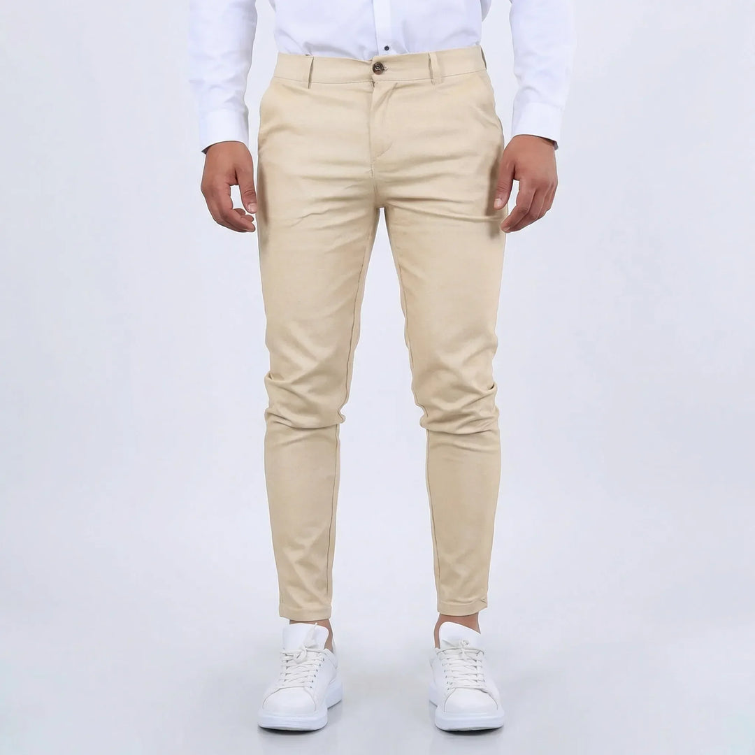 Beige men's slim fit tapered chino pants, perfect for smart casual outfits.