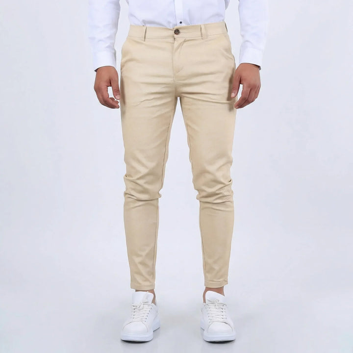 Beige men's slim fit tapered chino pants, perfect for smart casual outfits.