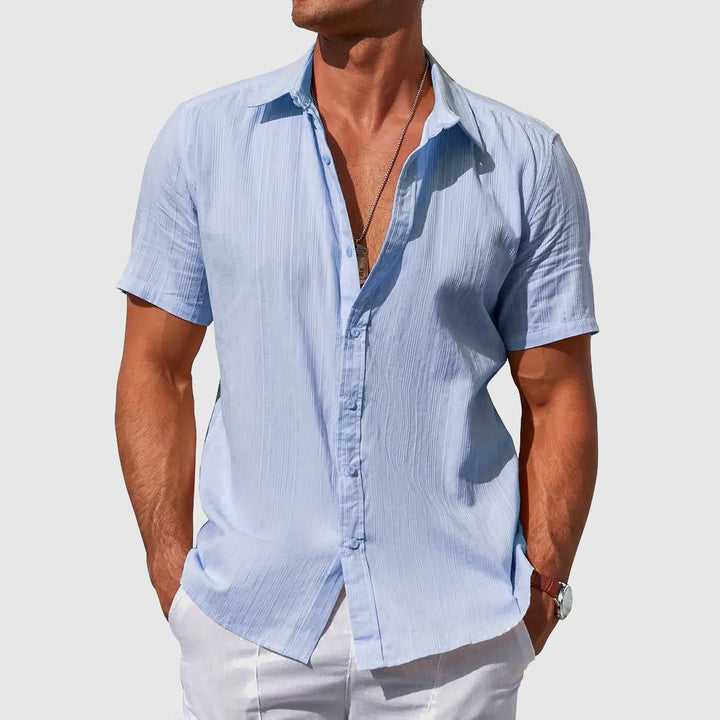 Men's textured casual short-sleeve button-front top. Relaxed fit, perfect for warm weather summer style.