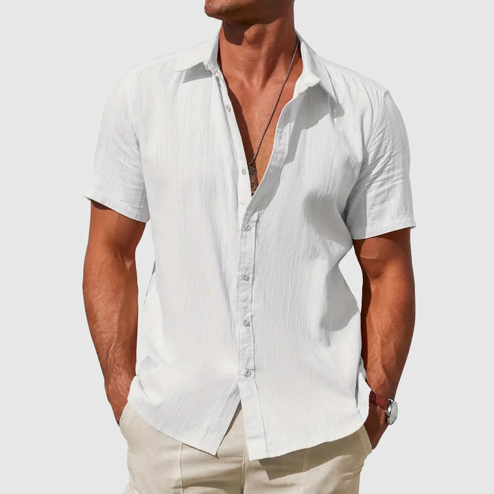 Stylish men's textured short-sleeve top. Button-front design for relaxed fit and warm weather comfort.