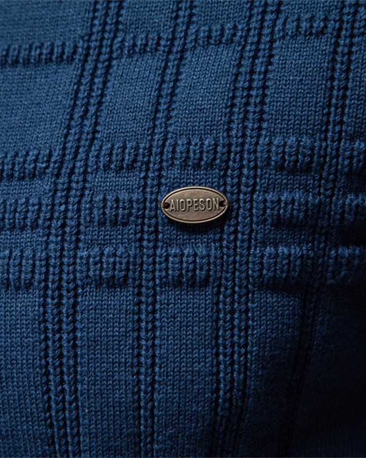 Lifestyle image of a man comfortably wearing a textured crew neck sweater outdoors