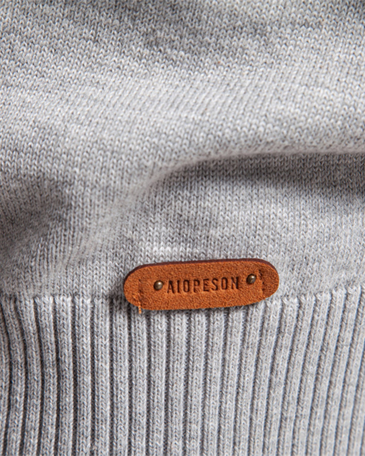 Man casually posing in a stylish textured crew neck sweater for a relaxed look