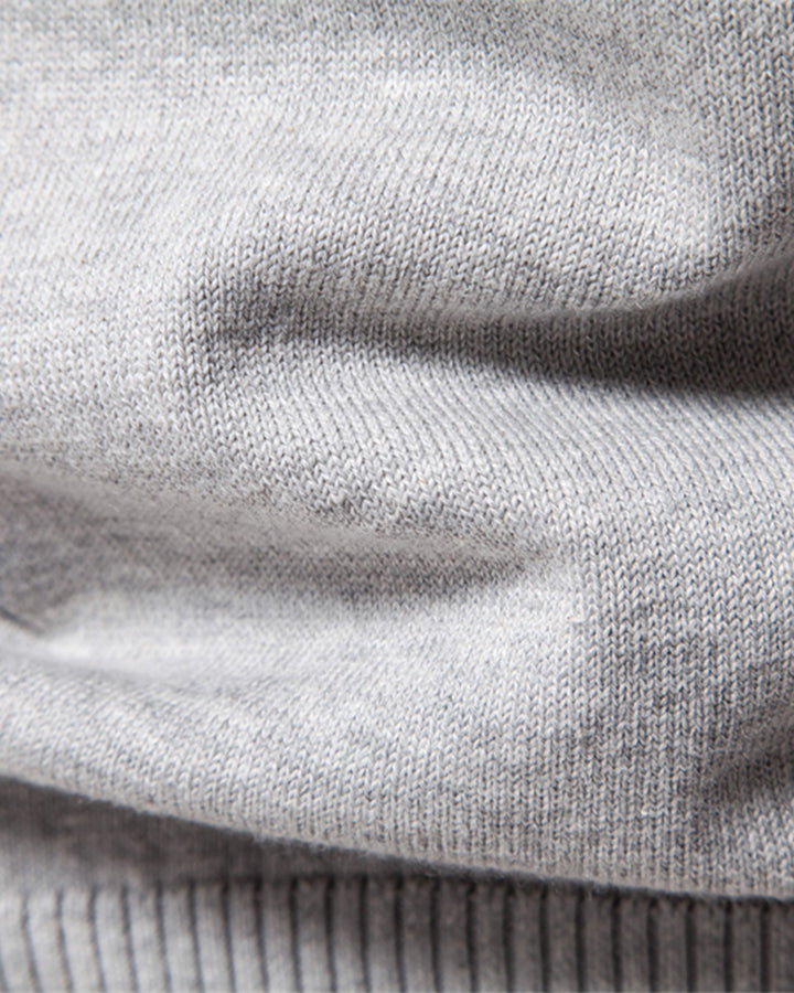 Flat lay of a men's textured crew neck sweater, ready for shipping