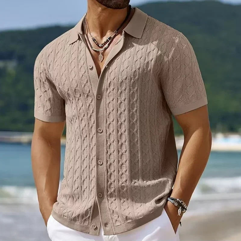 Black men's textured knit polo shirt with a button placket. Versatile smart casual top for men's fashion.