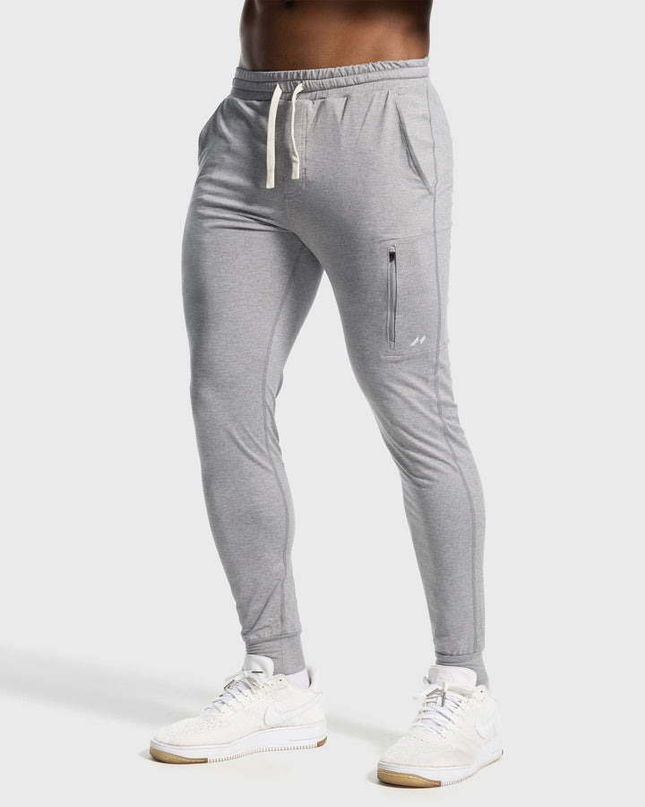 Stack of Men's Valencia Stretch Performance Joggers in various colors, ready for activewear