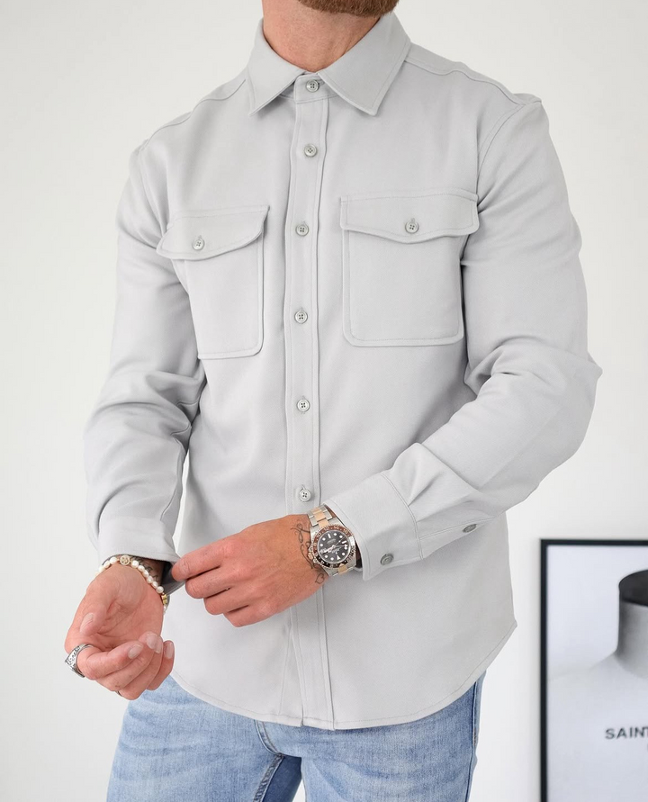Modern men's fashion: a smart casual button-up overshirt with long sleeves and functional chest pockets.