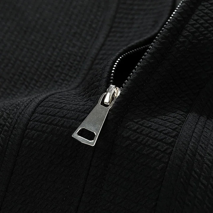 Black versatile relaxed fit zip-up sweater for men, great for layering & casual comfort.
