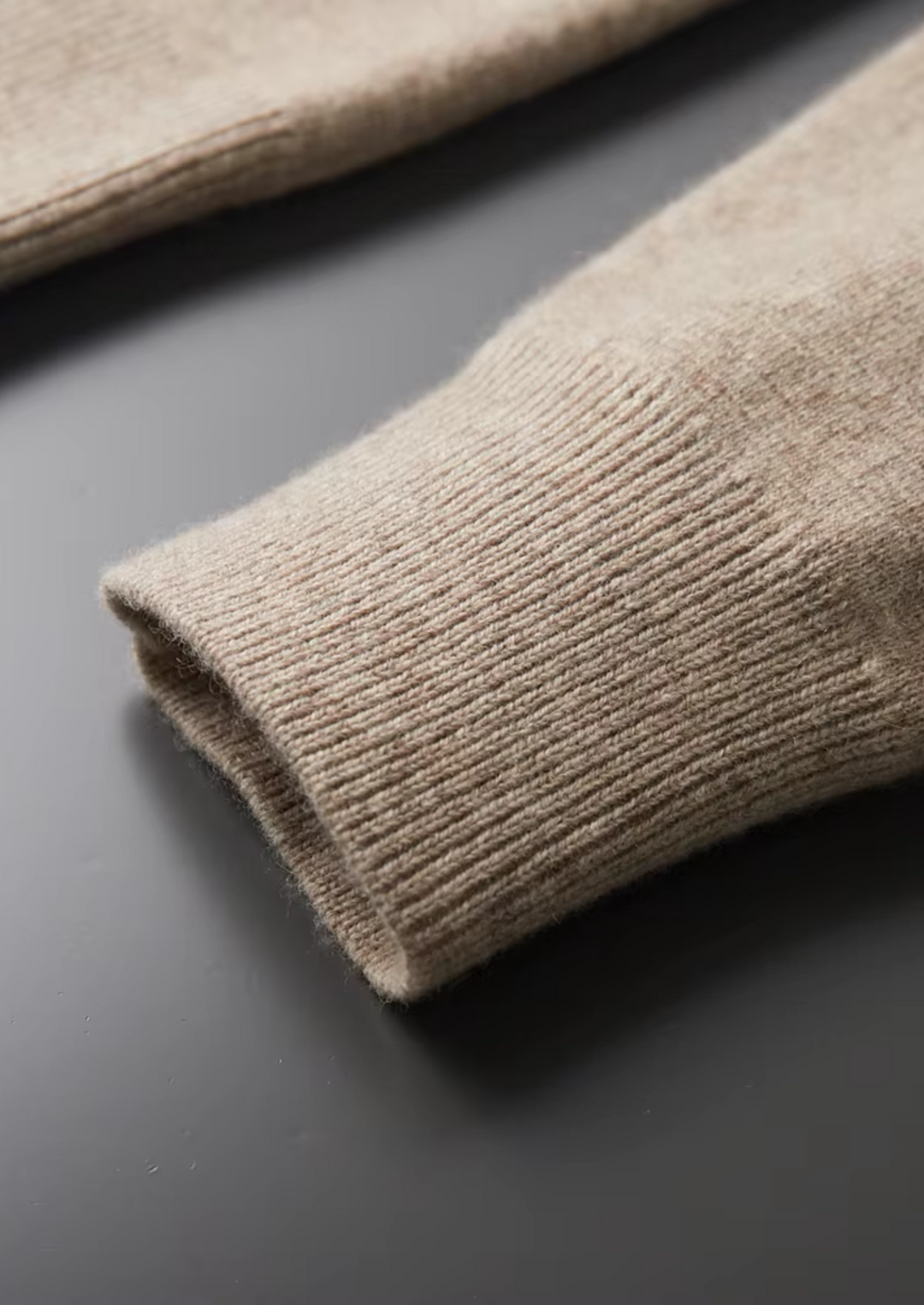 Men's all-season zip-up cardigan sweater draped casually, emphasizing its soft knit and comfort.