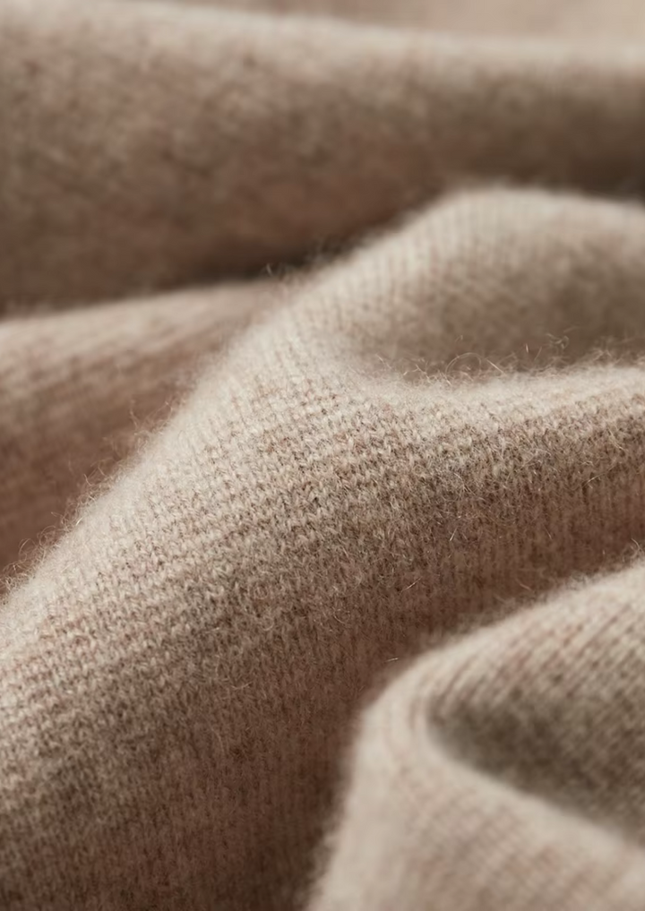 Detail shot of the sturdy zipper and collared neckline on a men's versatile cardigan sweater.