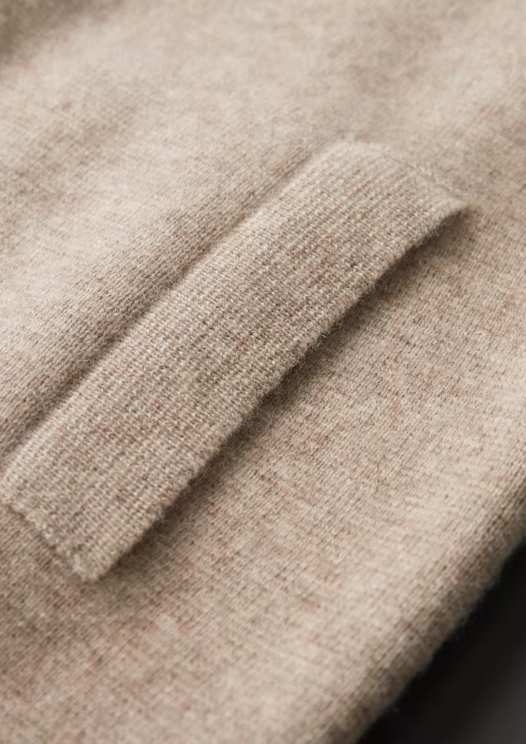 Men's zip-up cardigan sweater worn open over a shirt, showcasing its easy layering style.