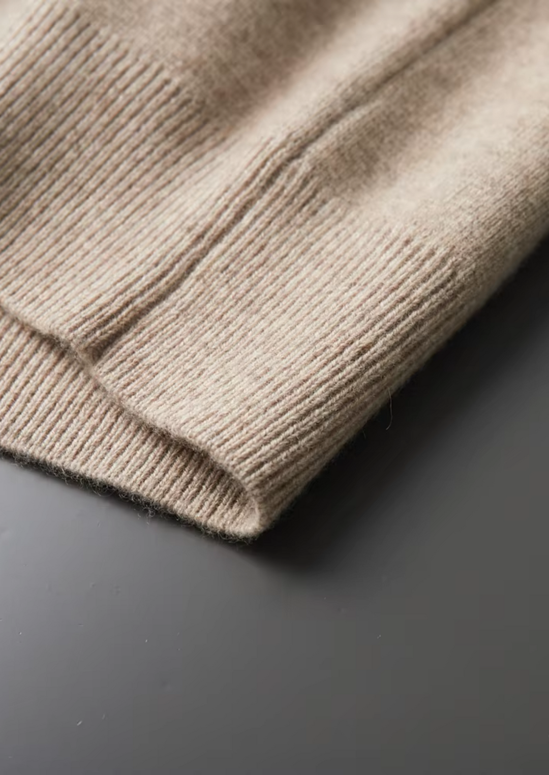 Neatly folded men's stylish zip-up cardigan sweater, ready for versatile casual or business casual wear.
