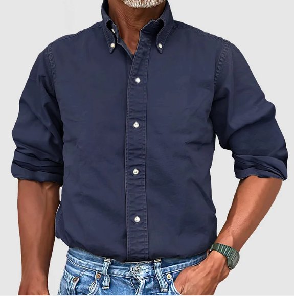Man wearing a relaxed fit vintage long sleeve button down shirt. Comfortable casual wear for a classic look.