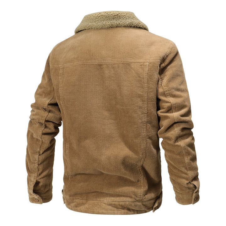 Men's sherpa-lined bomber jacket in a rustic outdoor setting, highlighting its winter coat function.