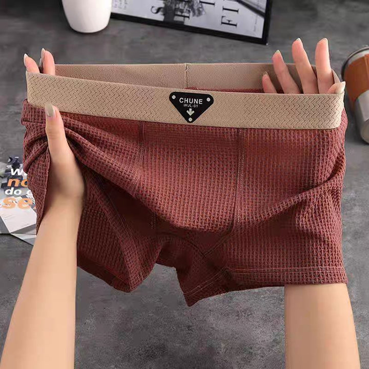 Close-up of soft waffle knit texture on men's boxer loungewear. Premium comfort men's underwear.