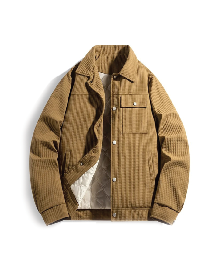 Detail shot of the quilted stitching on a men's waffle knit jacket, highlighting the winter coat's texture.