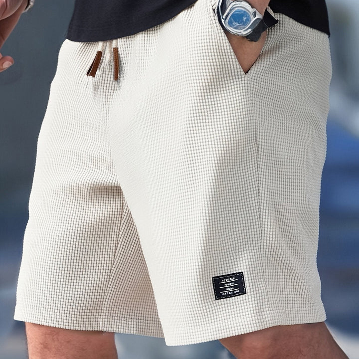 Comfortable men's waffle knit shorts, relaxed fit for loungewear or casual outfits. Soft fabric for summer.