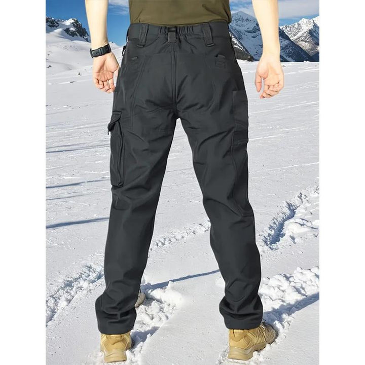 Pair of men's rugged cargo pants with fleece insulation, perfect for cold weather and outdoor adventures.